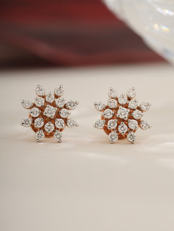 Pair of diamond earrings on a light background