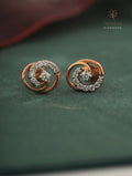 Rose gold earrings with diamond accents on a green surface, branded 'Tattvva Diamonds'.