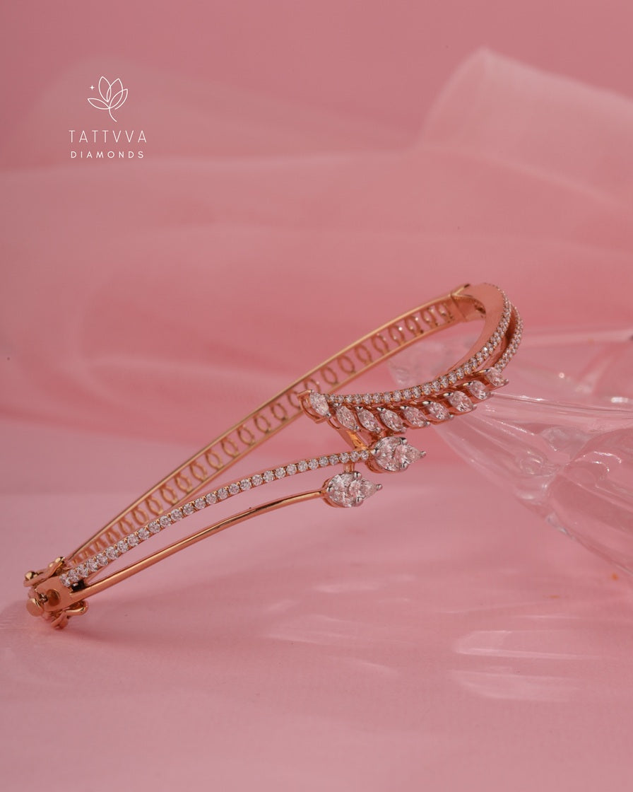 Rose gold bracelet with diamonds on a pink fabric background, featuring Tattvva Diamonds logo.