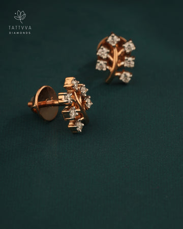 Rose gold earrings with diamonds on a dark green background, branded 'Tattvva Diamonds'.