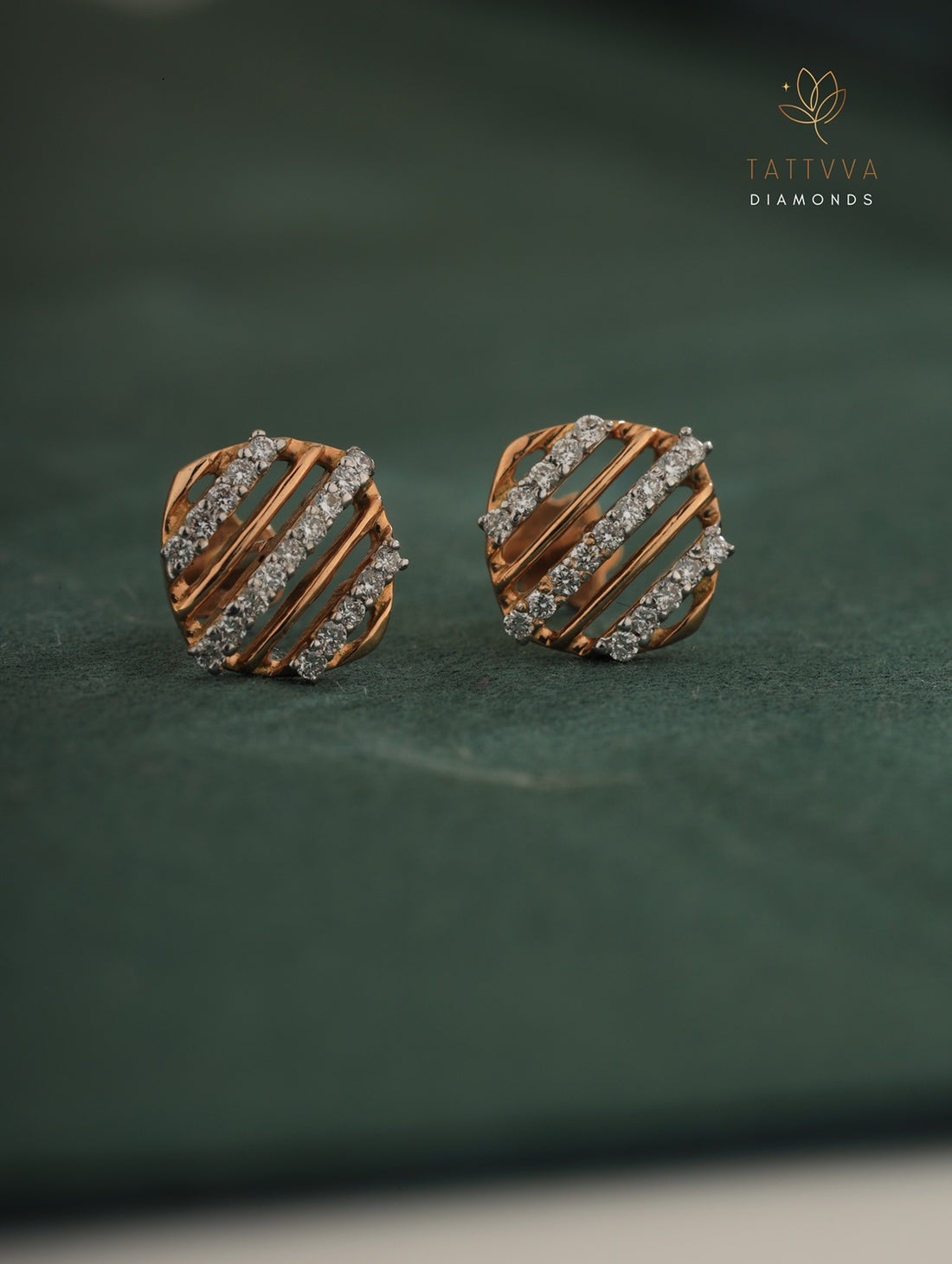 Pair of diamond-studded earrings on a green background with Tattvva Diamonds logo.