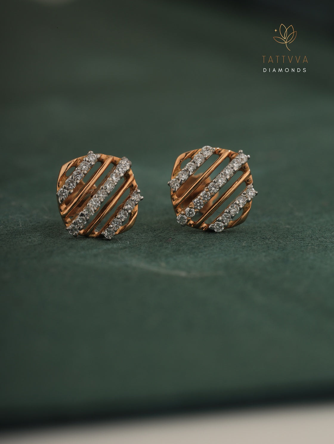 Pair of diamond-studded earrings on a green background with Tattvva Diamonds logo.