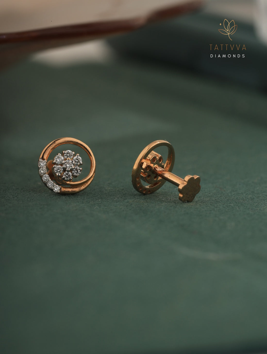 Rose gold earrings with diamond accents on a green background, branded 'Tattvva Diamonds'.