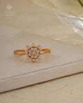 Gold ring with diamond accents on a beige surface, branded 'Tattvva Diamonds'.