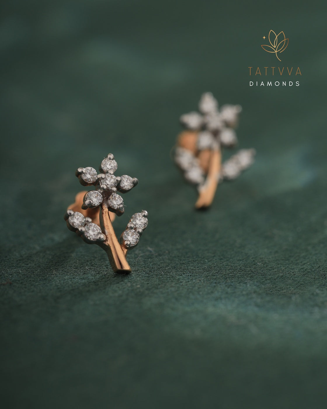 Diamond earrings on a green fabric background with Tattvva Diamonds logo.