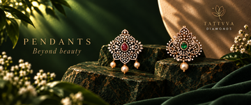 Two ornate gold-toned diamond pendants with red and green stones and pearl drops, displayed on dark stone blocks with green foliage and draped fabric in a styled setting. The brand name 'TATVVA DIAMONDS' is visible in the top right.