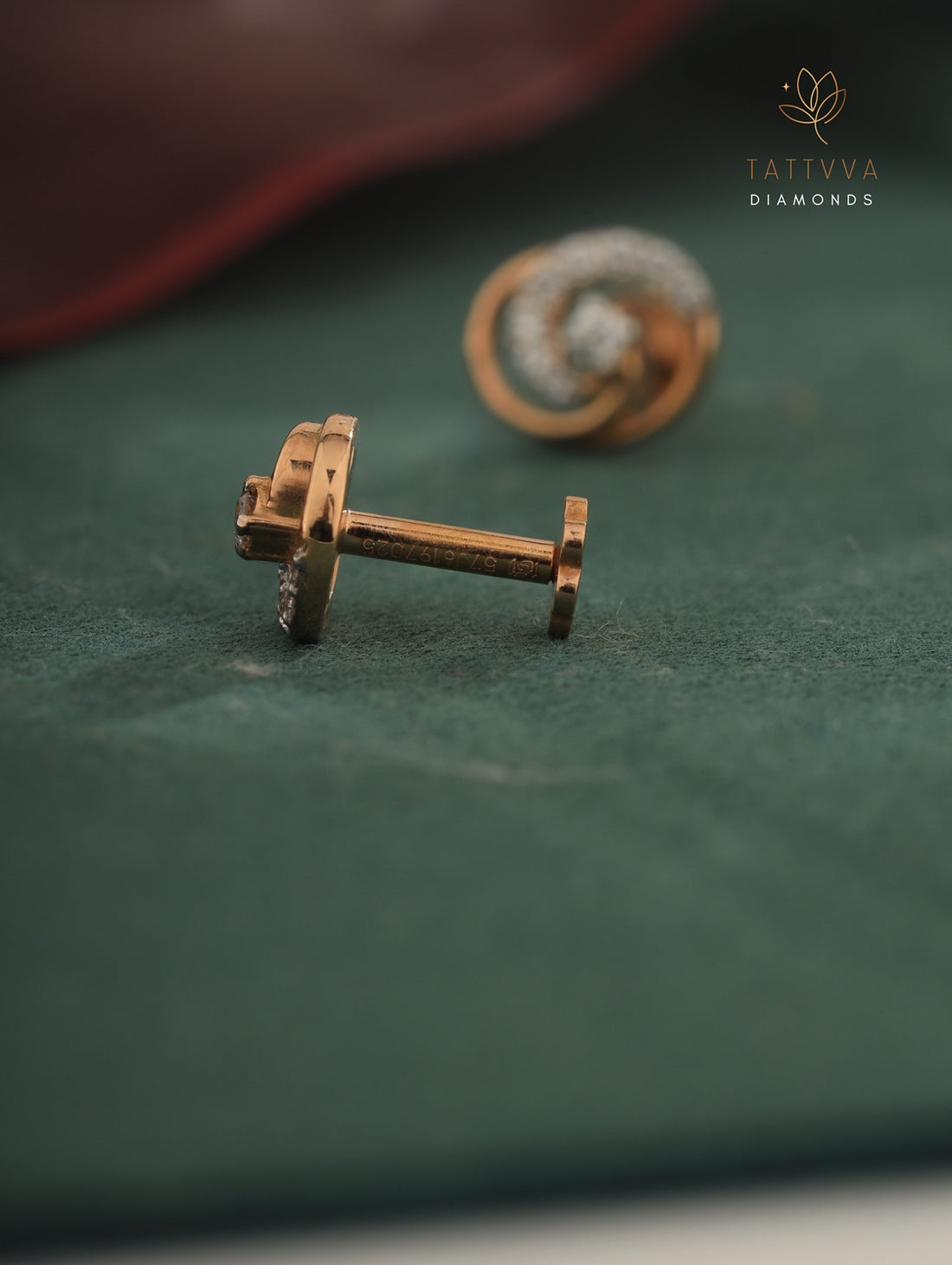 Rose gold earrings with diamond accents on a green surface, branded 'Tattvva Diamonds'.