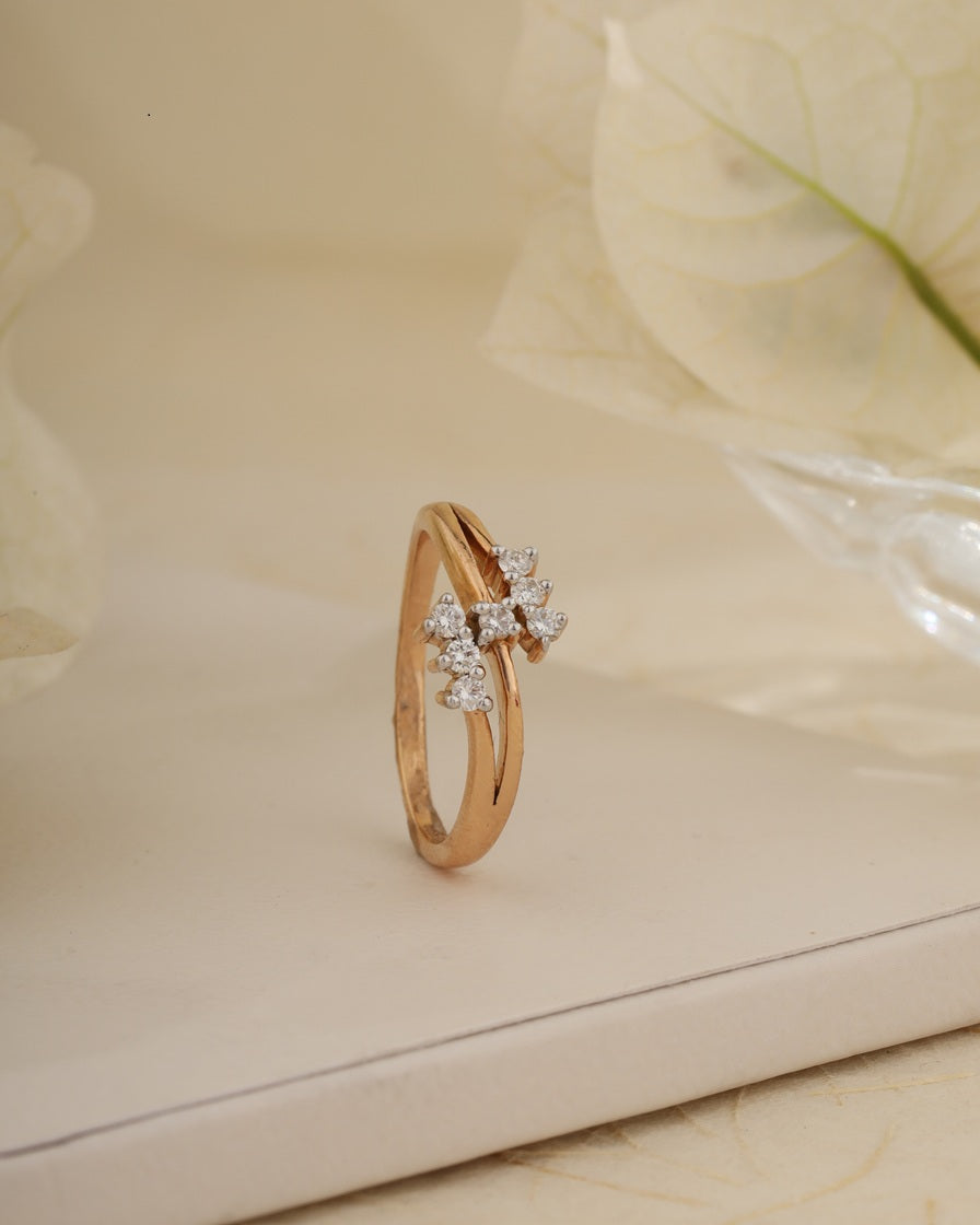 Rose gold ring with diamonds on a light background